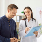 Young man patient visiting female doctor in office during medical examination.