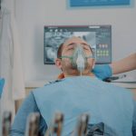Patient with oxygen mask receiving anesthesic in dentistry cabinet